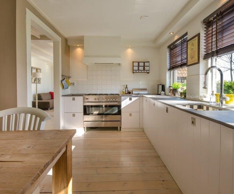 A kitchen with wooden cabinets and a dining table