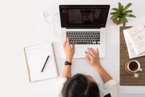 A person sitting in front of a laptop