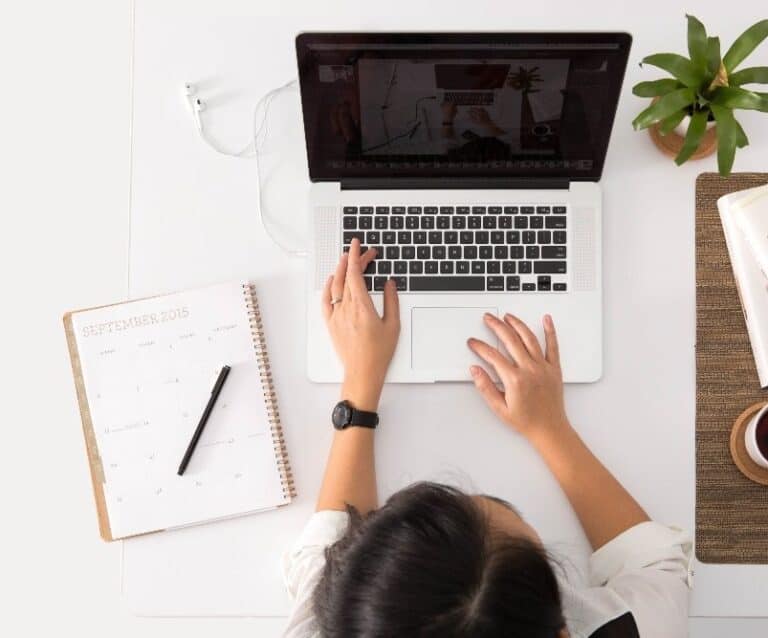 A person sitting in front of a laptop