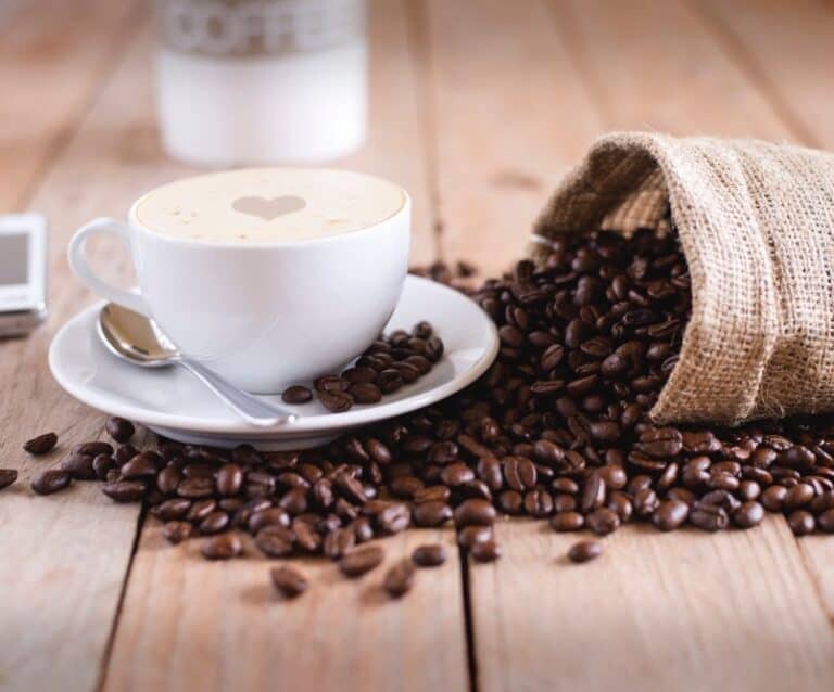 A cup of coffee sitting on top of a wooden table