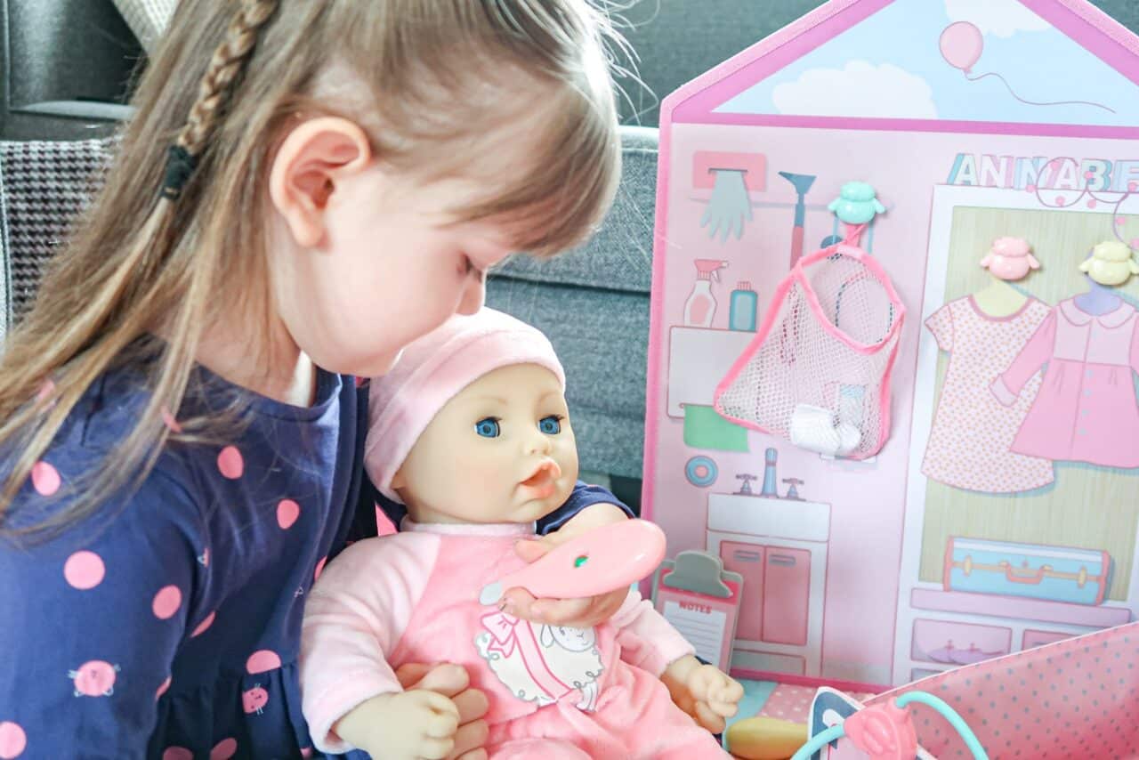 A little girl holding a baby