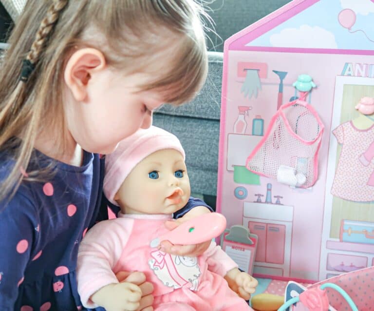 A little girl holding a baby