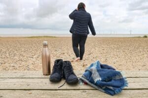 A person sitting on a sandy beach