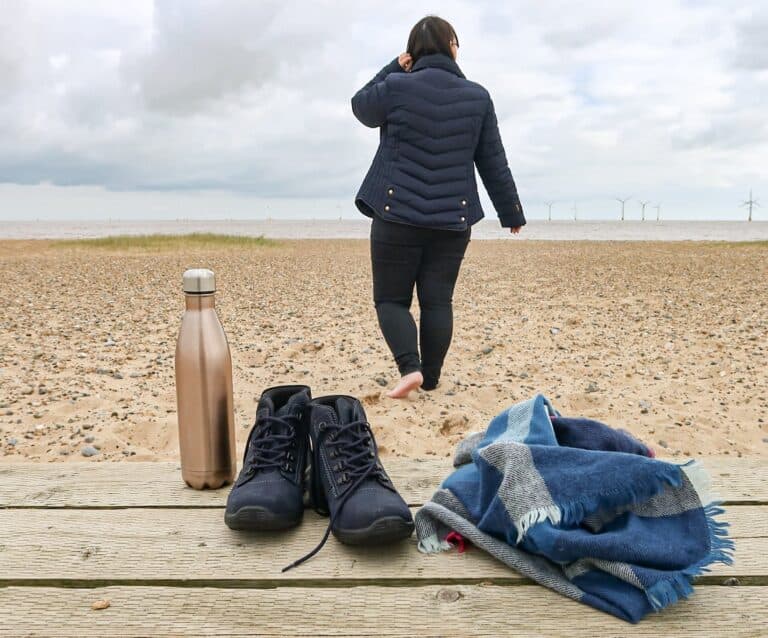 A person sitting on a sandy beach