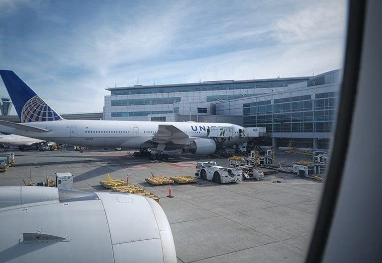 A large passenger jet sitting on top of a tarmac at an airport