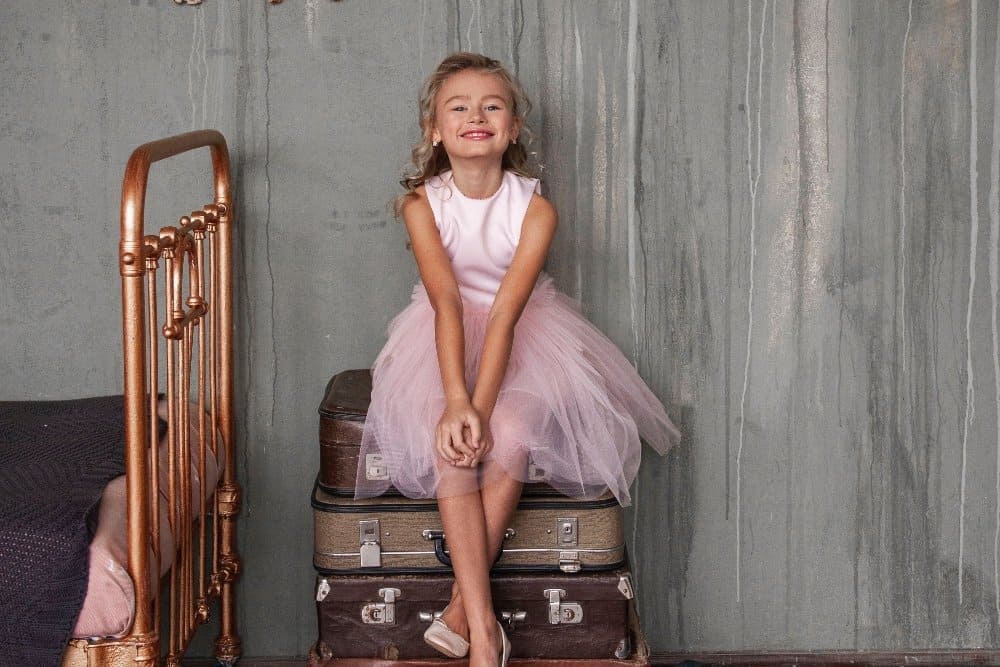 A person sitting on a suitcase