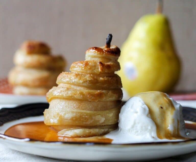 A piece of cake on a plate, with Pastry and Pear