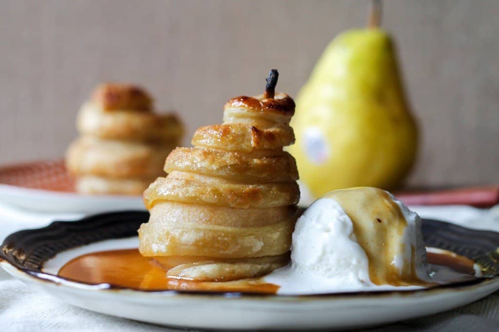 A piece of cake on a plate, with Pastry and Pear