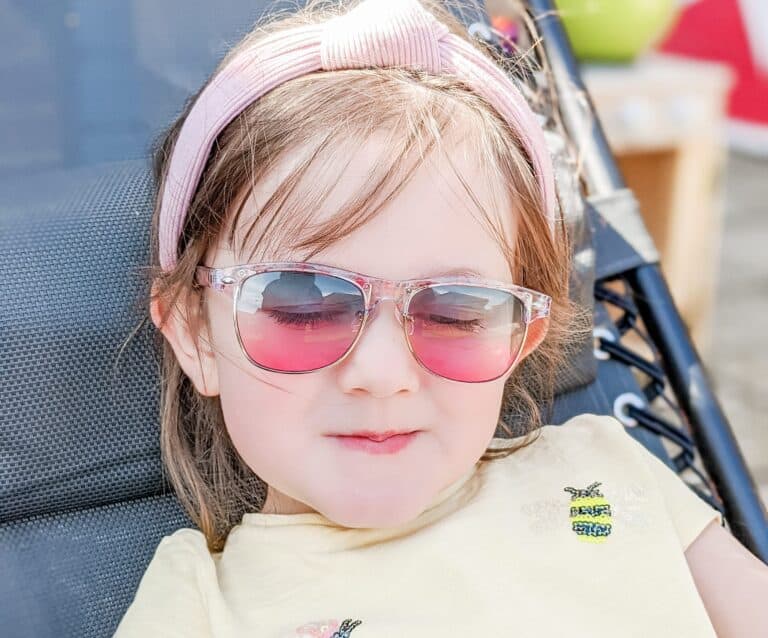 A person wearing sunglasses posing for the camera