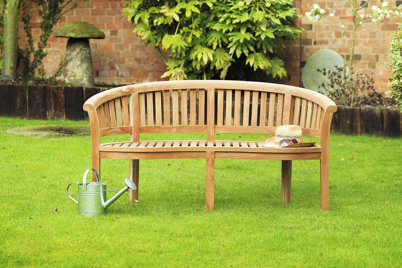 A wooden bench sitting on top of a lush green field