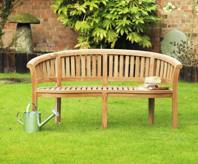 A wooden bench sitting on top of a lush green field