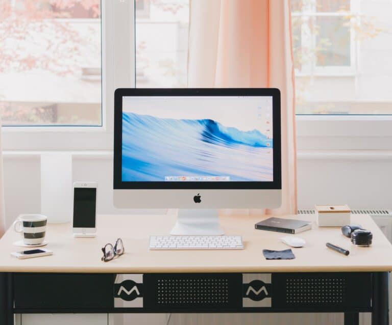 A desktop computer monitor sitting on top of a desk