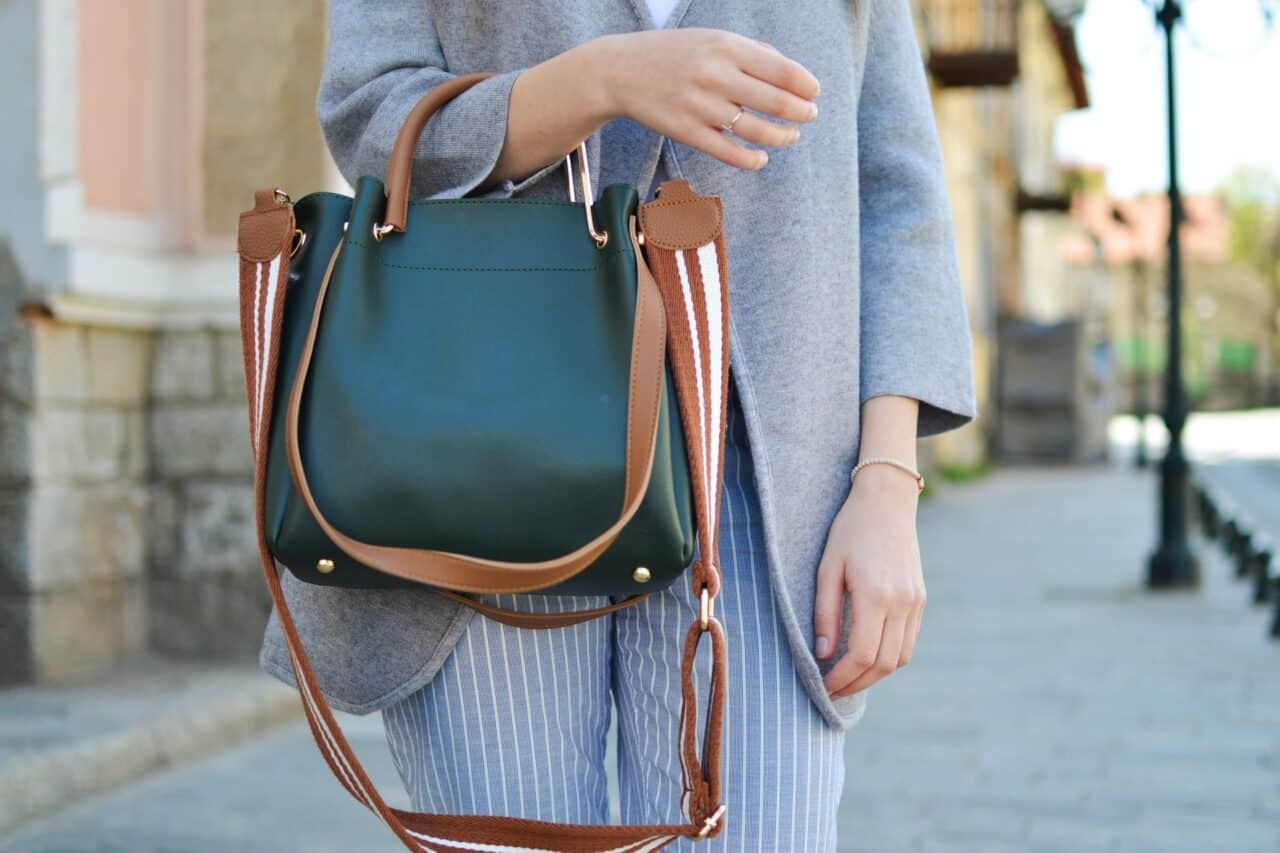 A person holding a bag of luggage