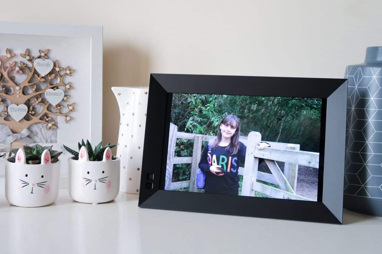 A digital photo frame is sitting on a table