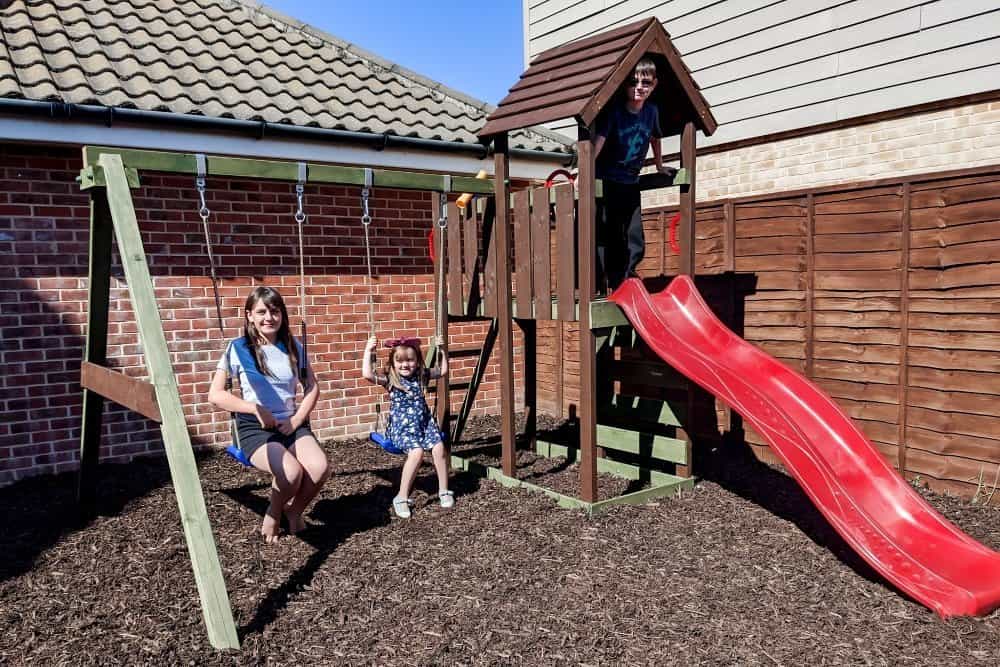 Children playing on a wooden climbing frame