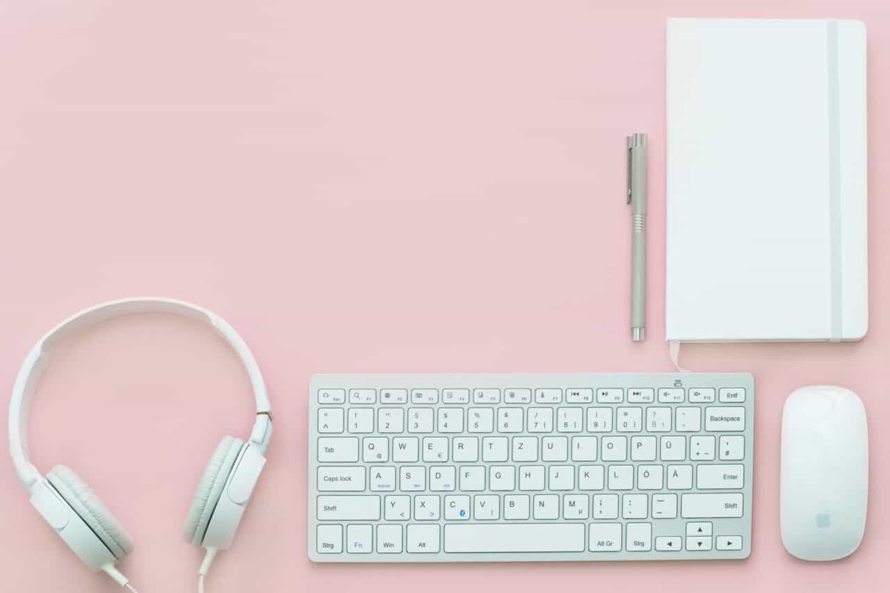 A close up of a computer keyboard on a pink background