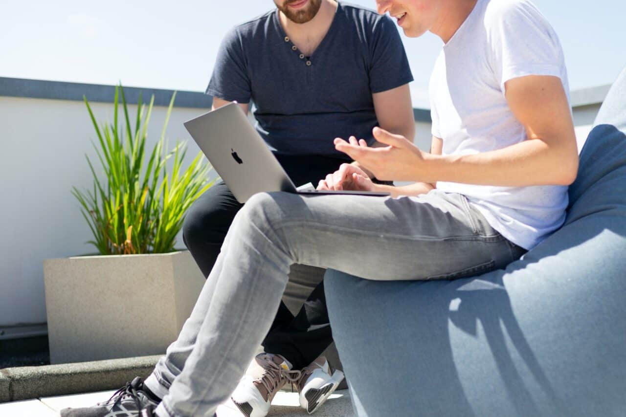 A person sitting at a table using a laptop