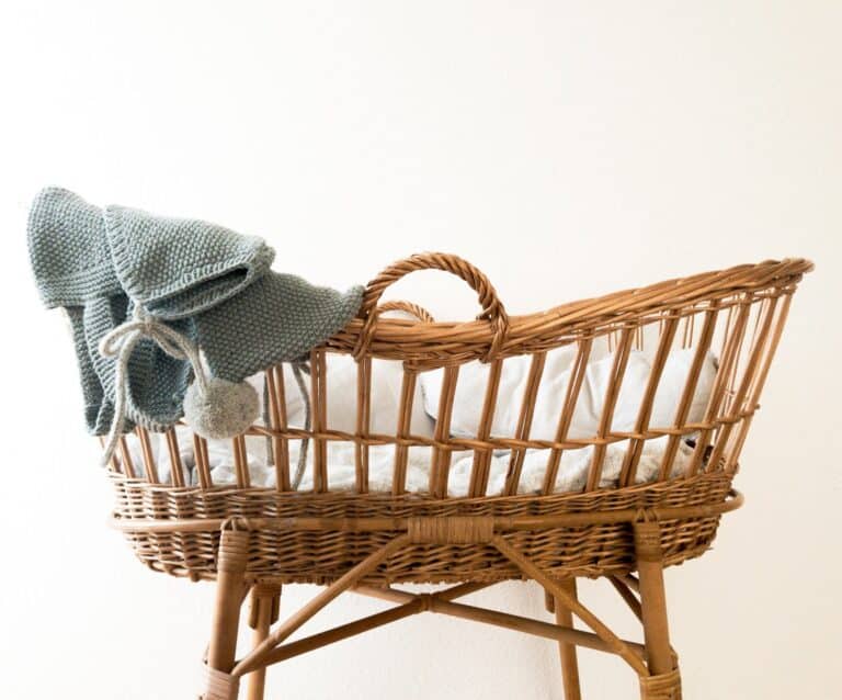 wicker moses basket with grey blanket