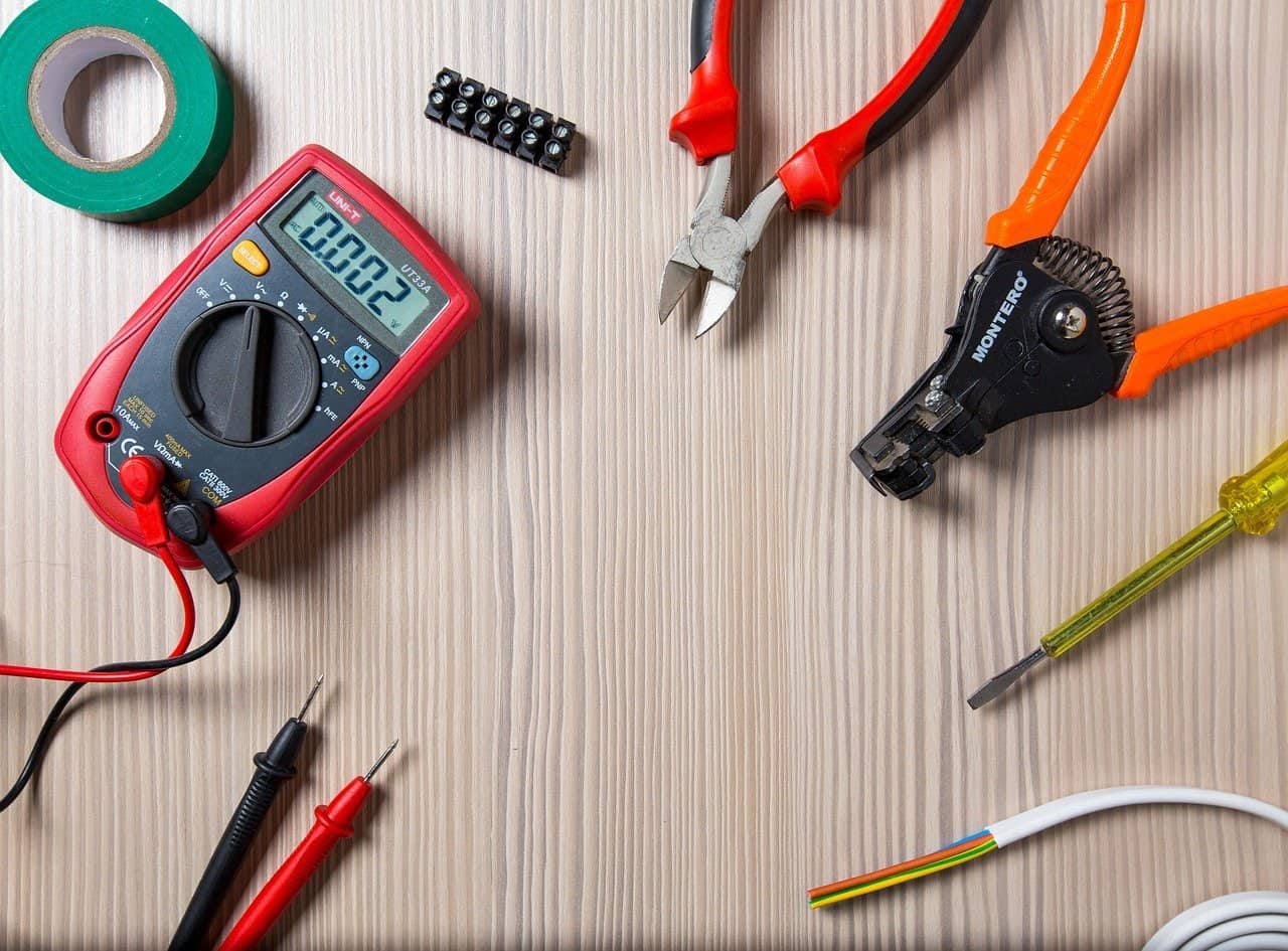 A wooden table with electrician tools