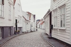 empty roadway between white houses