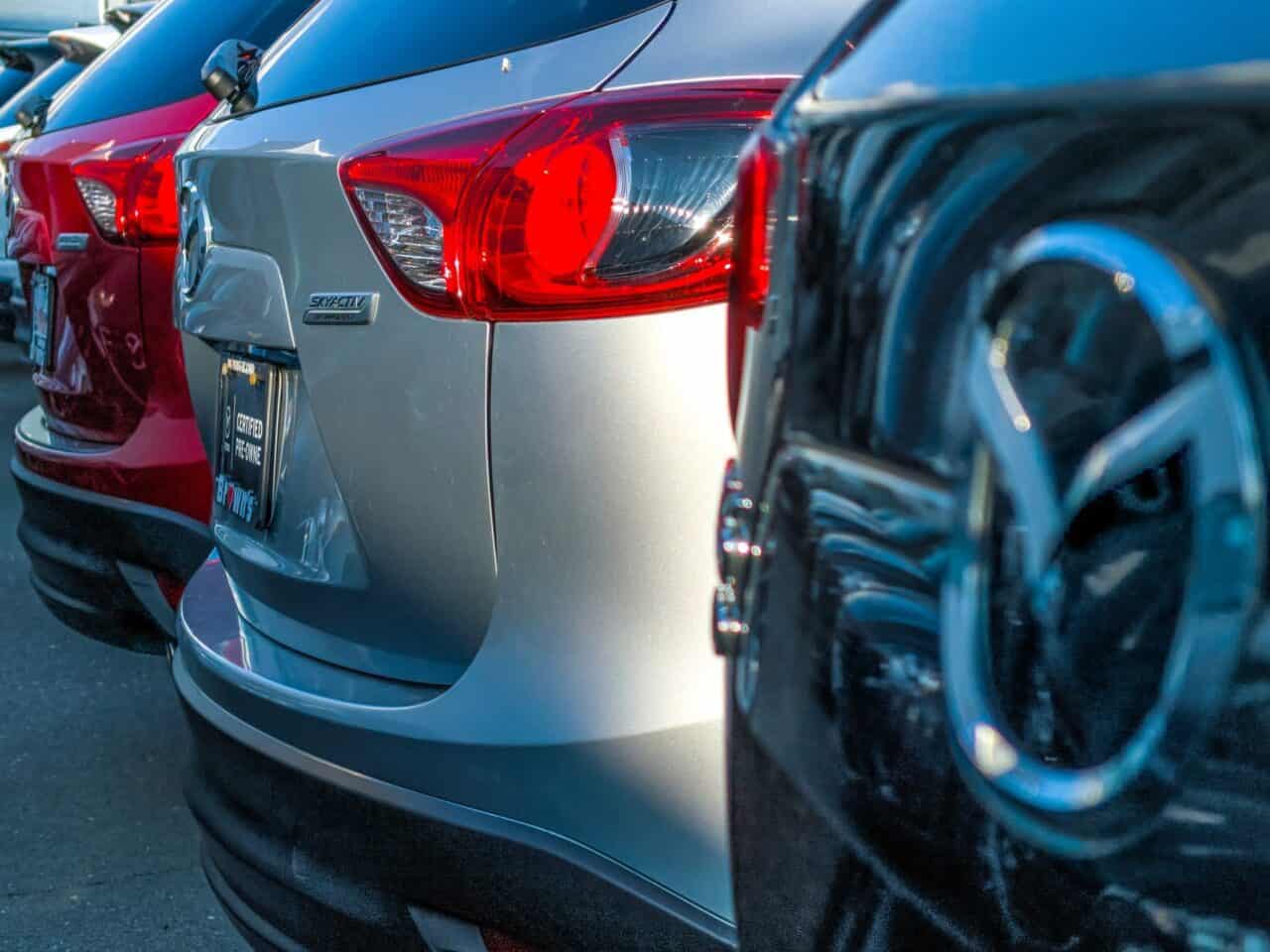 A row of mid sized SUV's on a sunny day