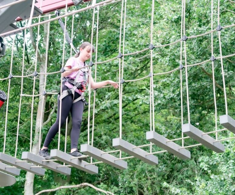 teenager completing a high ropes course