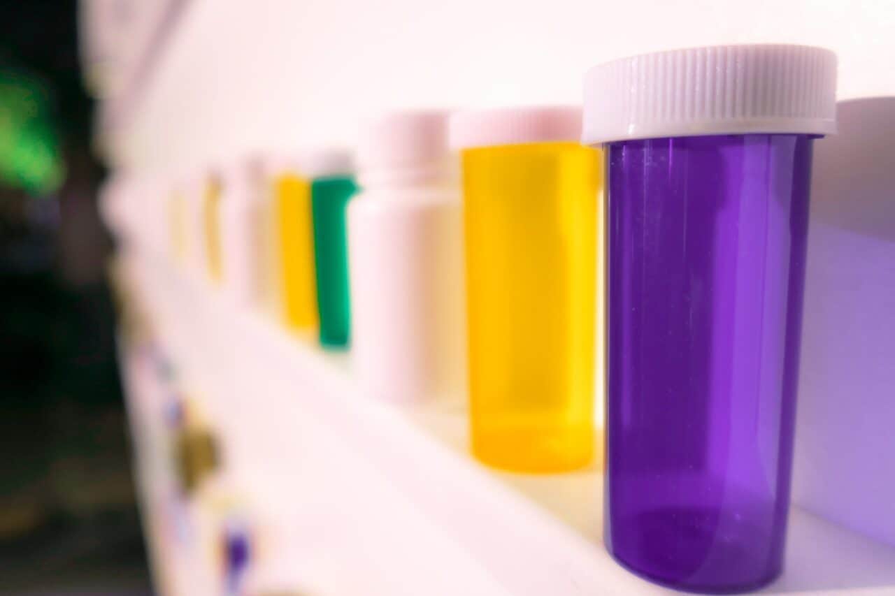 shelves of pill bottles with thousands of pills on the floor