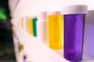 shelves of pill bottles with thousands of pills on the floor