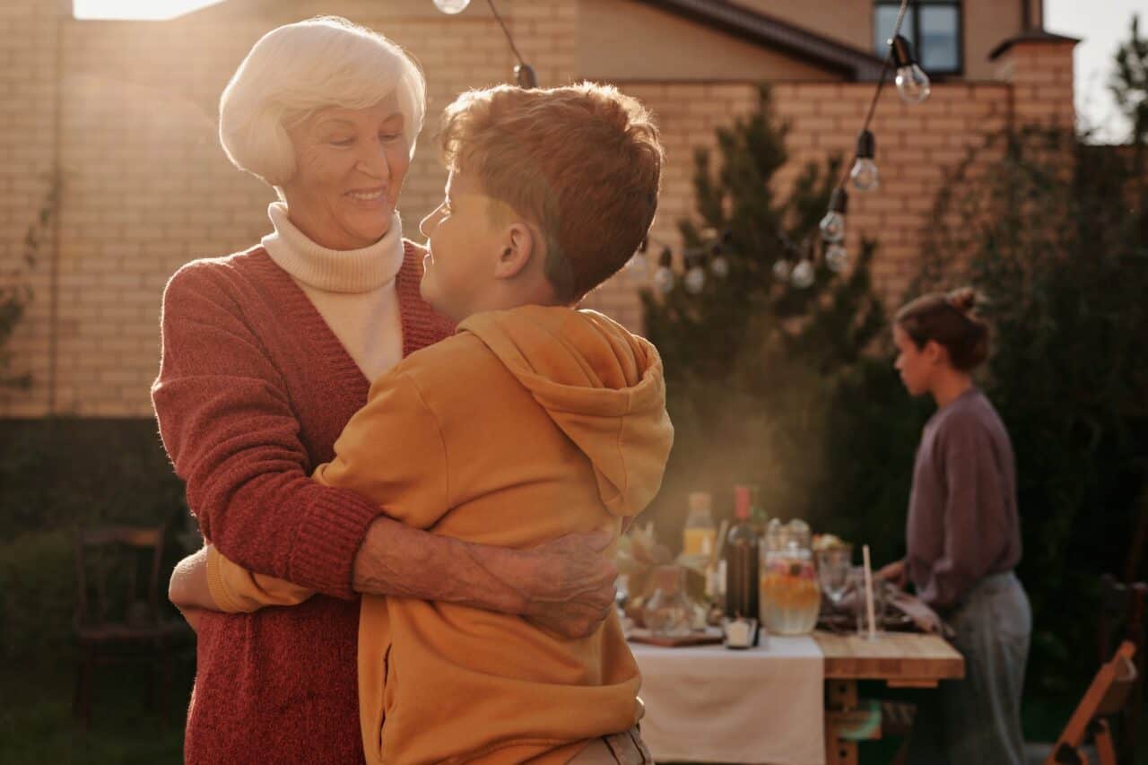 elderly woman hugging her grandson