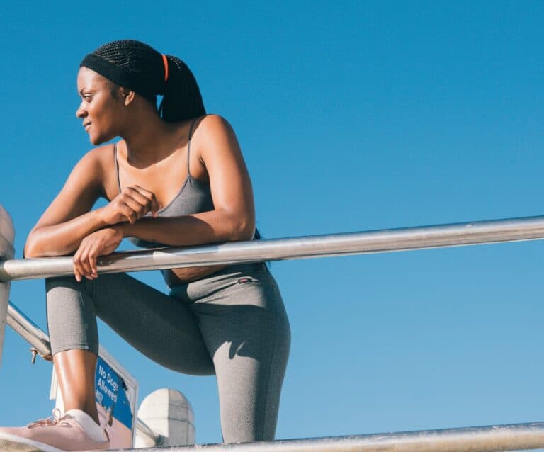 woman in black tank top and gray leggings