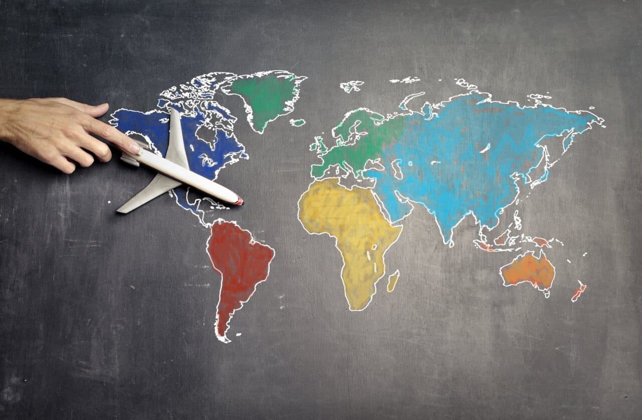 Top 5 Business Ideas for Travelers - person with toy airplane on world map