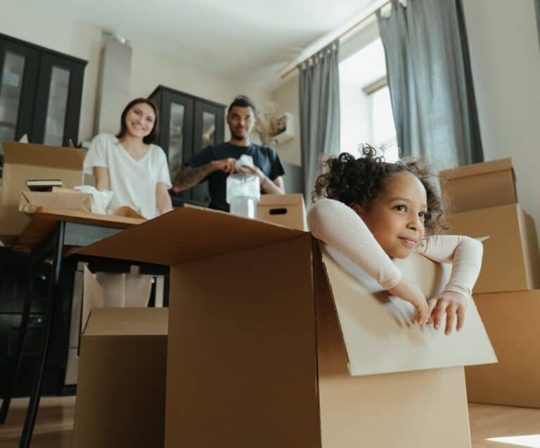 little girl playing in a box