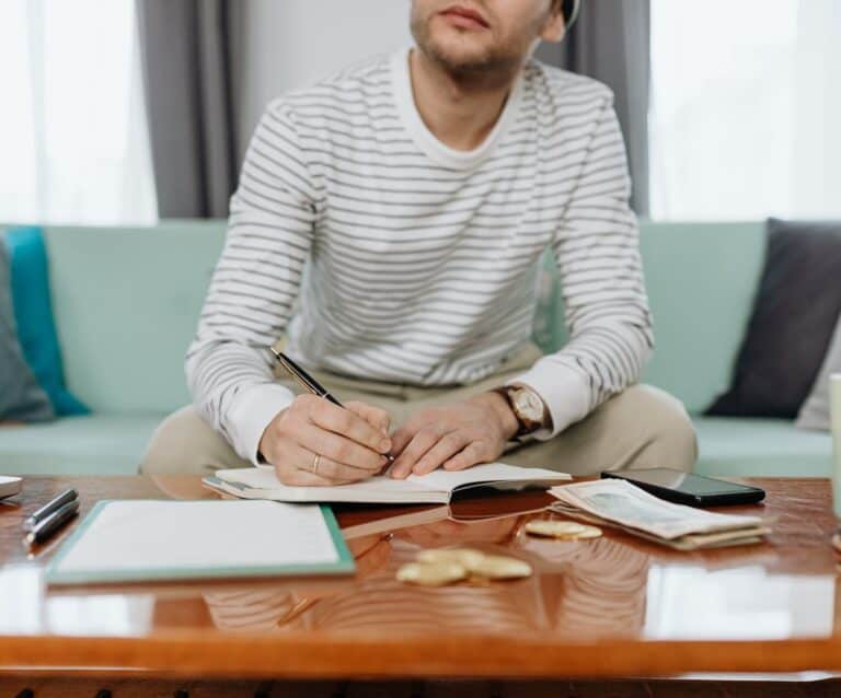 man in white and gray striped long sleeve shirt sitting at the table