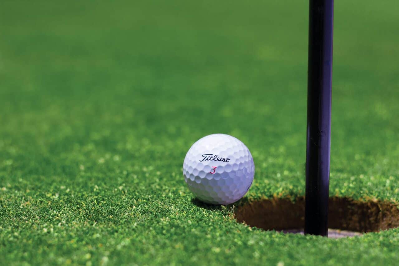 8 Interesting Golf Facts You Didn't Know About - titrist golf ball near golf hole