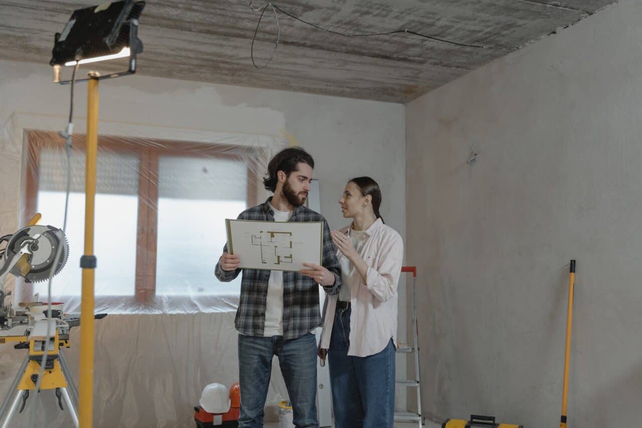 couple holding a blueprint