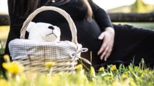 Mortgages: what to expect when you’re expecting - pregnant woman sitting on grass near picnic basket