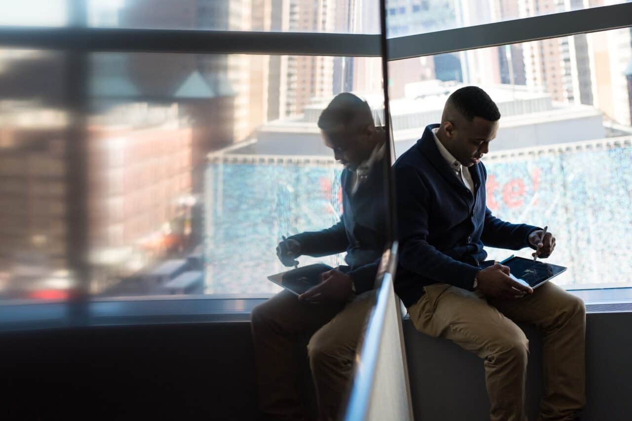 man sitting beside window