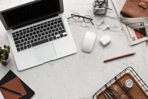 flatlay display of electronics next to eyeglases