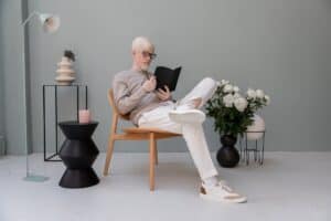 businessman reading diary on chair in room with decor