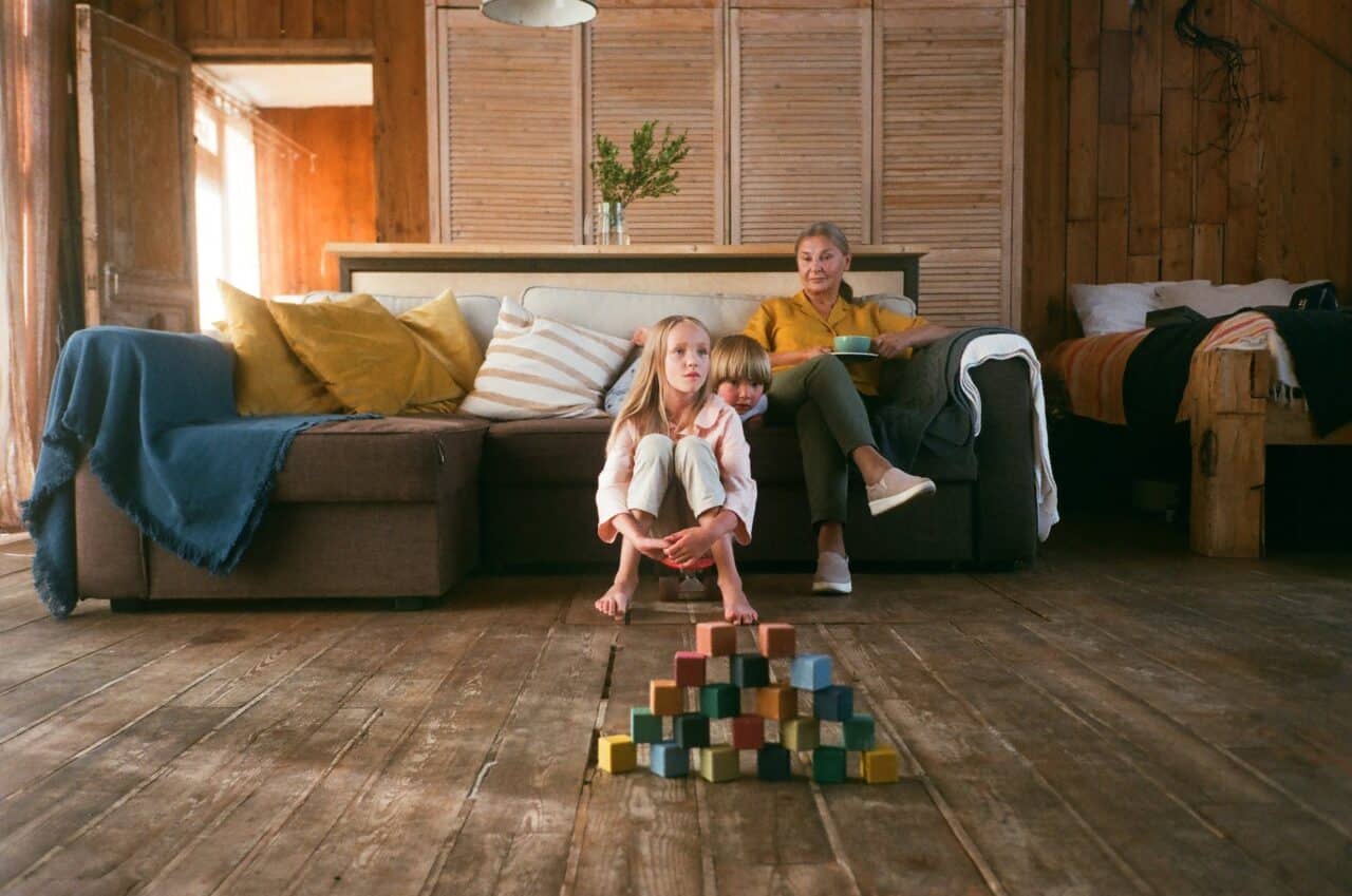 woman sitting on a couch looking after two children