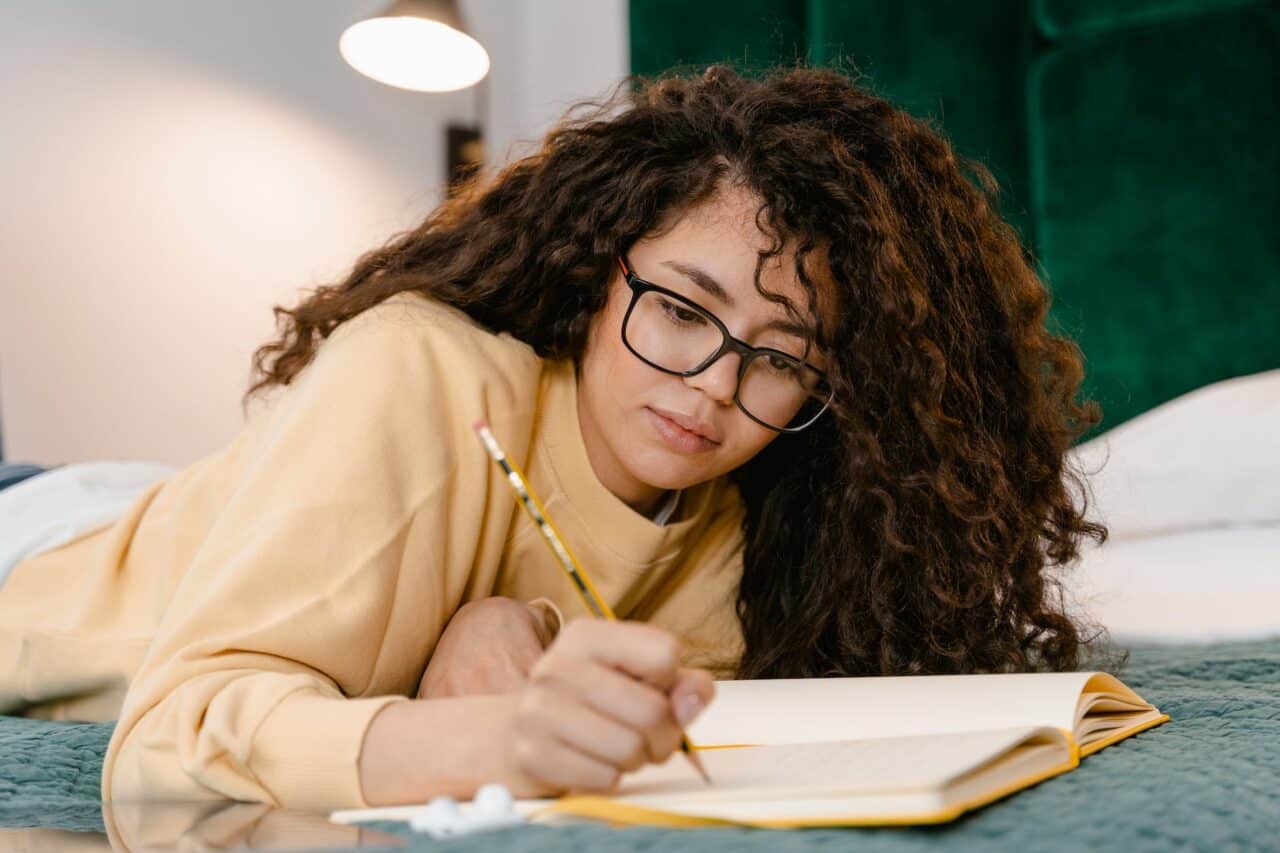 girl writing on a notebook