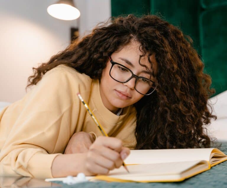 girl writing on a notebook