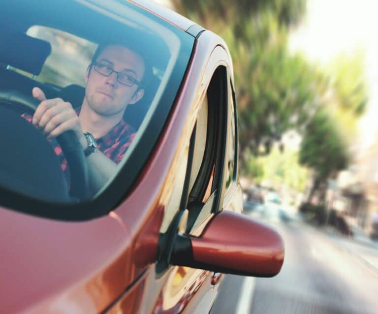 man driving the red vehicle