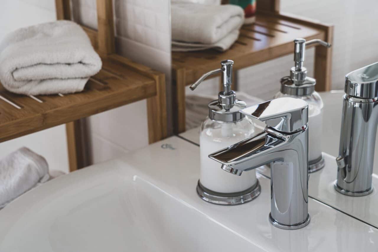 stainless steel faucet on white ceramic sink