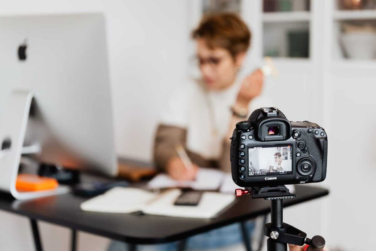 professional photo camera taking photos of anonymous businesswoman