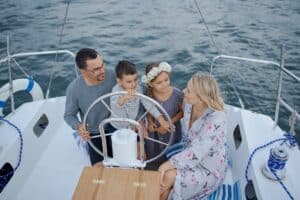 happy family on yacht sailing on sea during trip