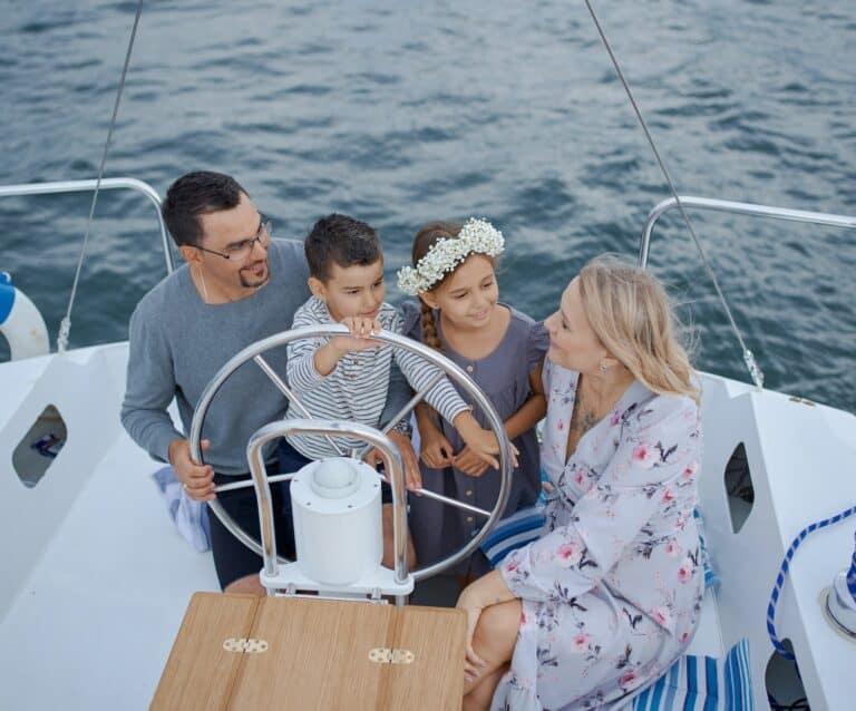 happy family on yacht sailing on sea during trip