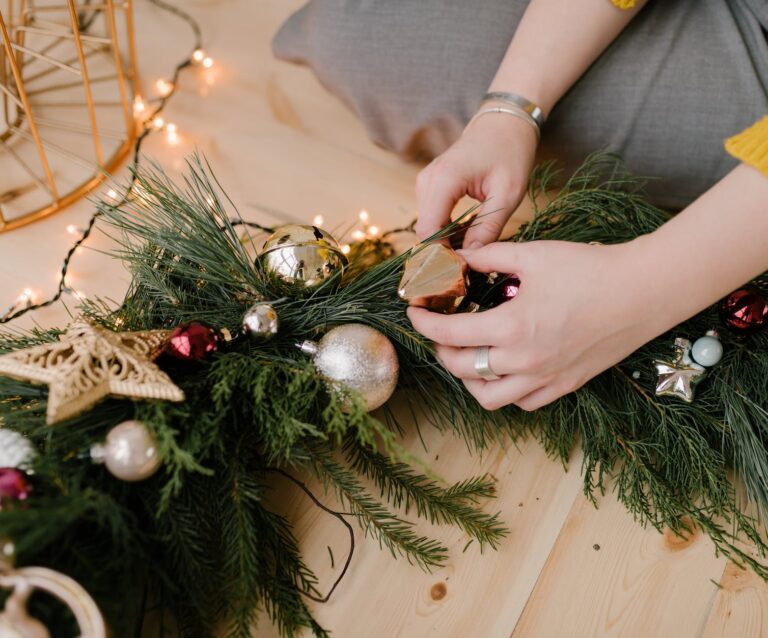 close up shot of a person holding a christmas wreath