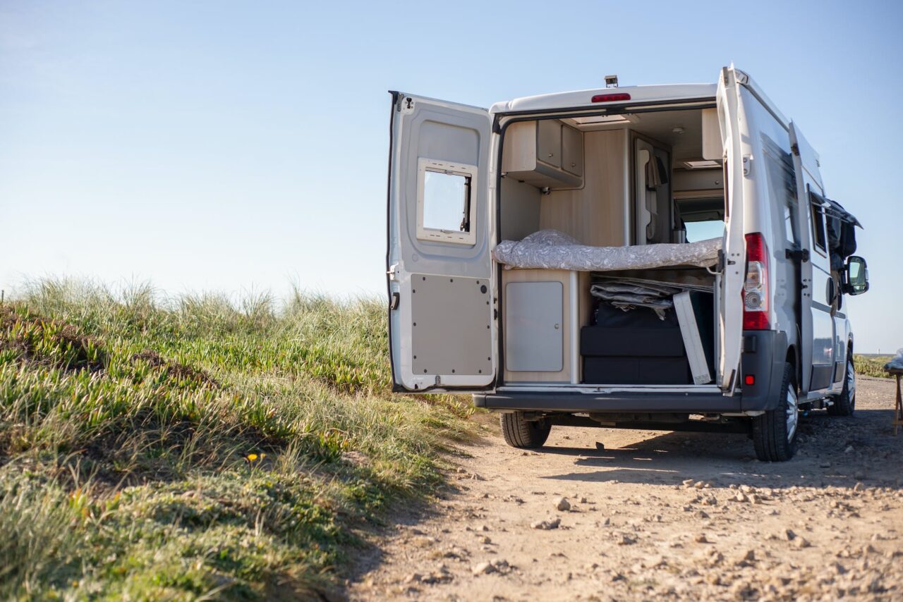 white and brown camper trailer on brown field