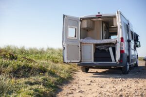 white and brown camper trailer on brown field